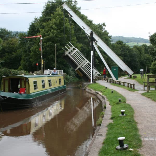 Our electric canal boat cruises under the electric lift bridge in Talybont